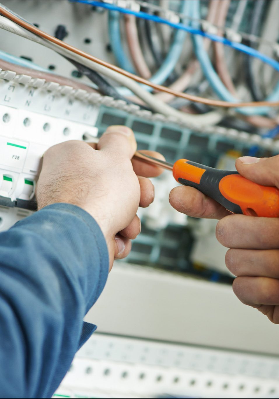 An image of an electrician testing a fuse box